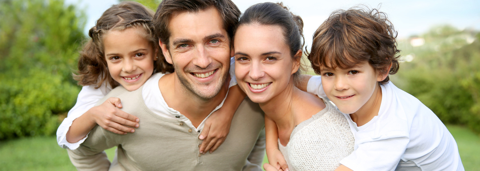 Parents giving piggyback ride to children